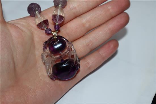 A Chinese amethyst and rock crystal pendant hung from a carved amethyst and rock crystal necklace, pendant 38mm.